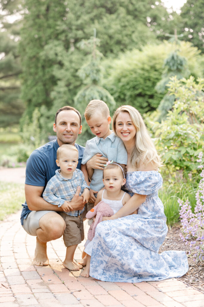 family of 5 dressed in blues and whites pose for their edina family photography session at arneson acres park, minnesota