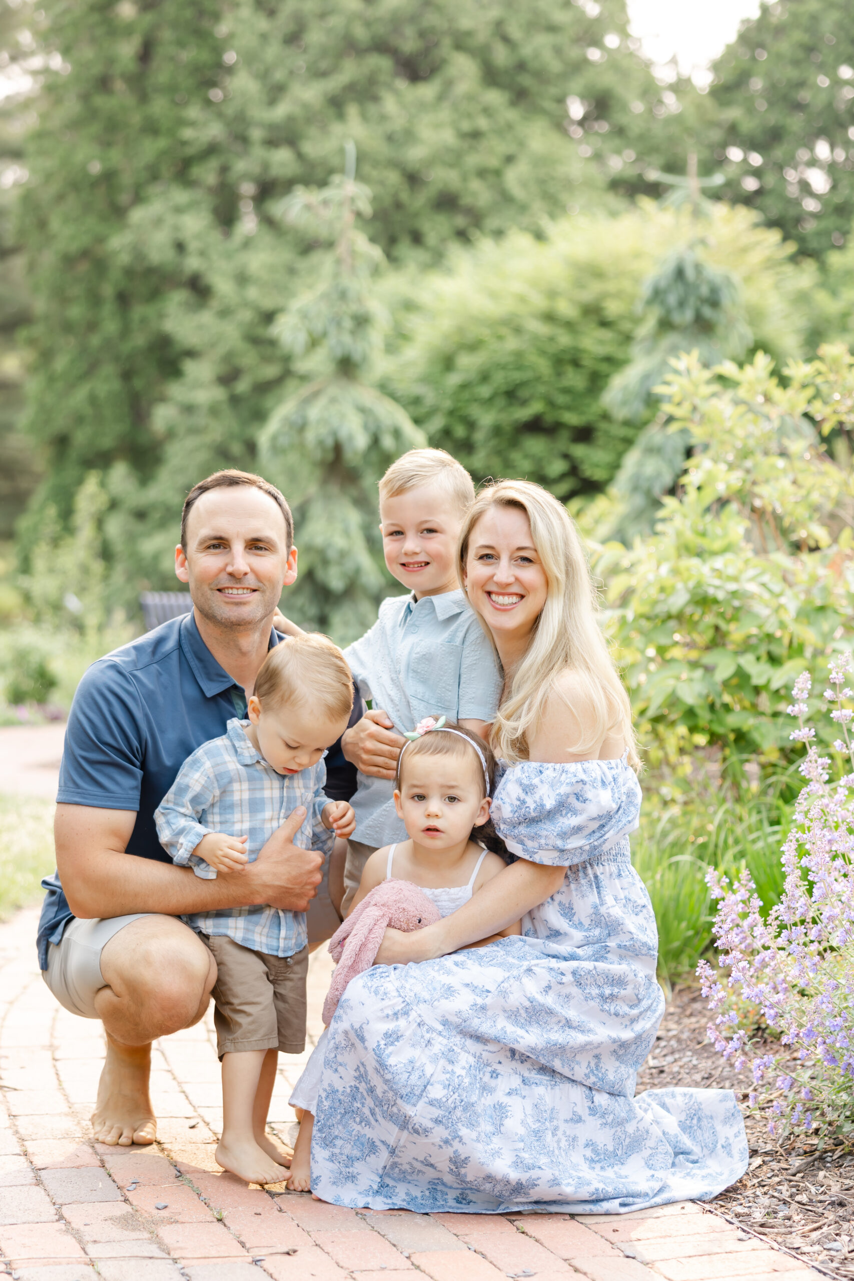 Family of 5 snuggle at arneson acres park in edina, mn for their minneapolis family photography session