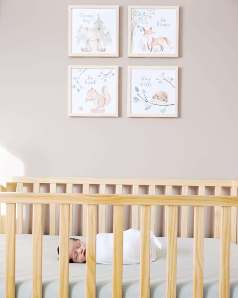newborn baby in his crib during his minneapolis in-home newborn photography session with angela watts photography