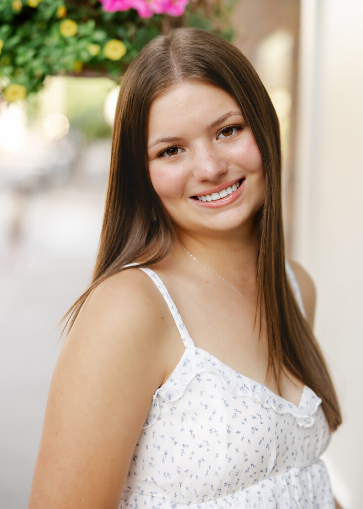 Girl in jeans and white tank takes her eden prairie senior photos downtown excelsior with senior photographer angela watts photography