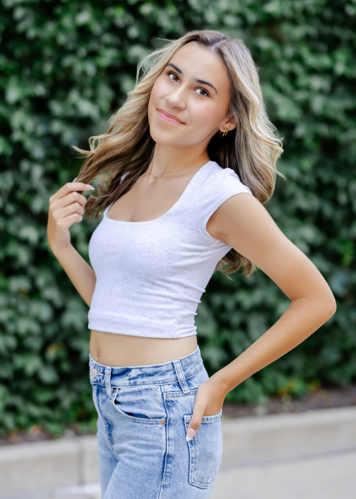 Wayzata high school senior poses at mill ruins park for her wayzata senior pictures with angela watts photography
