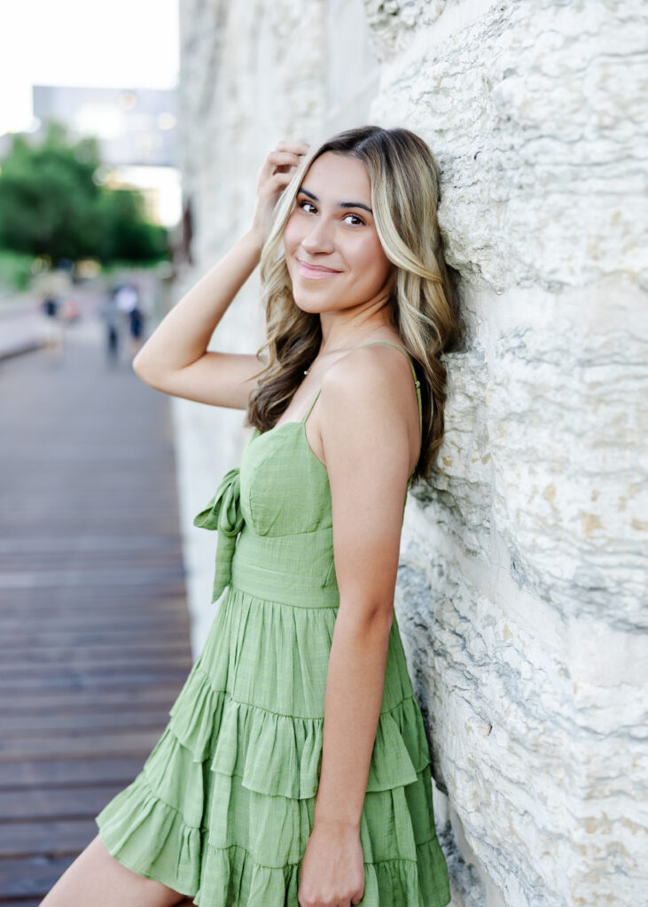 Wayzata high school senior poses at mill ruins park for her wayzata senior pictures with angela watts photography