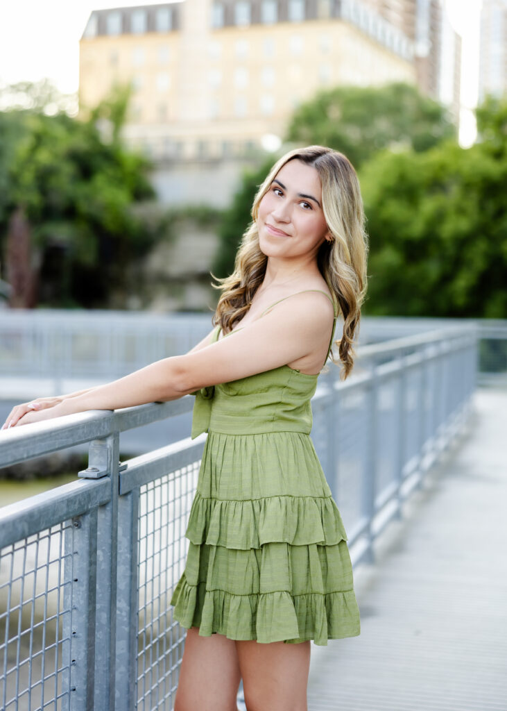 Wayzata high school senior poses at mill ruins park for her wayzata senior pictures with angela watts photography