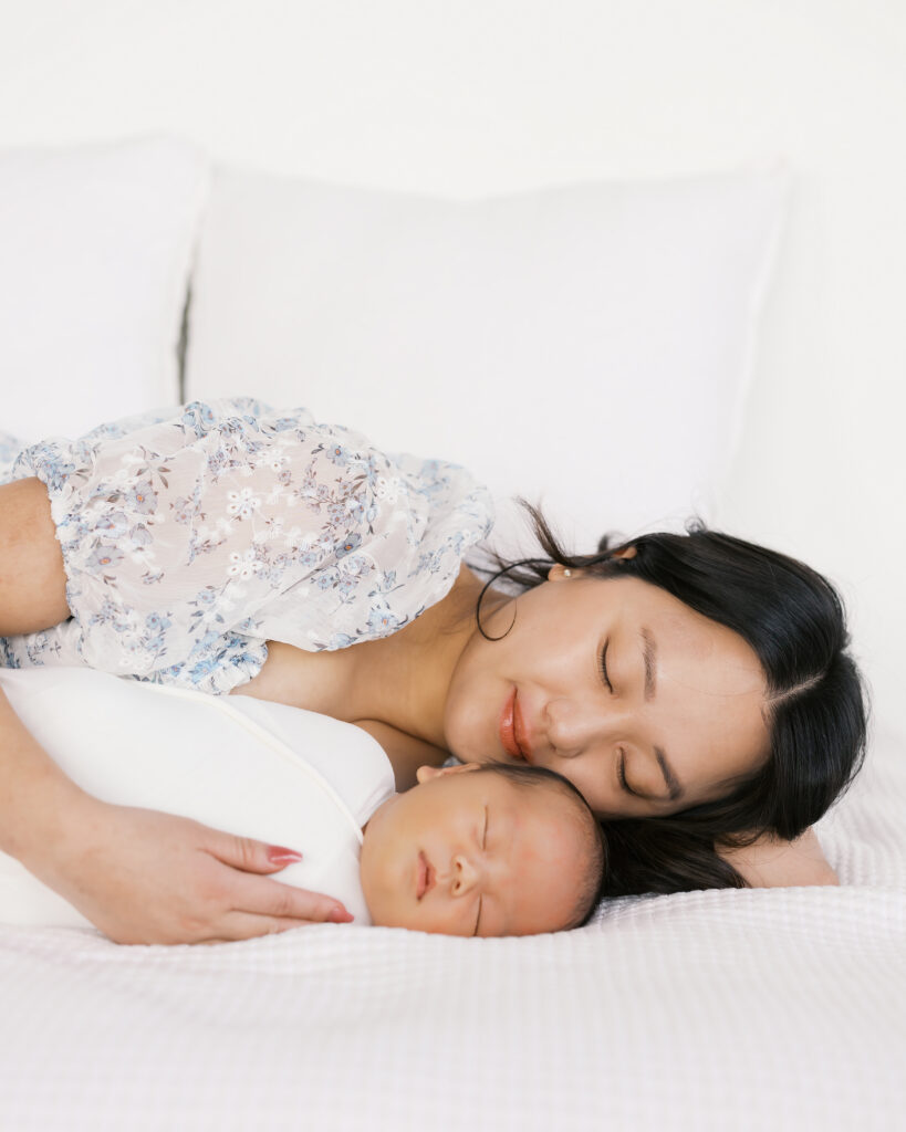 Mom and baby snuggle close during their minneapolis studio newborn photography session with angela watts photography